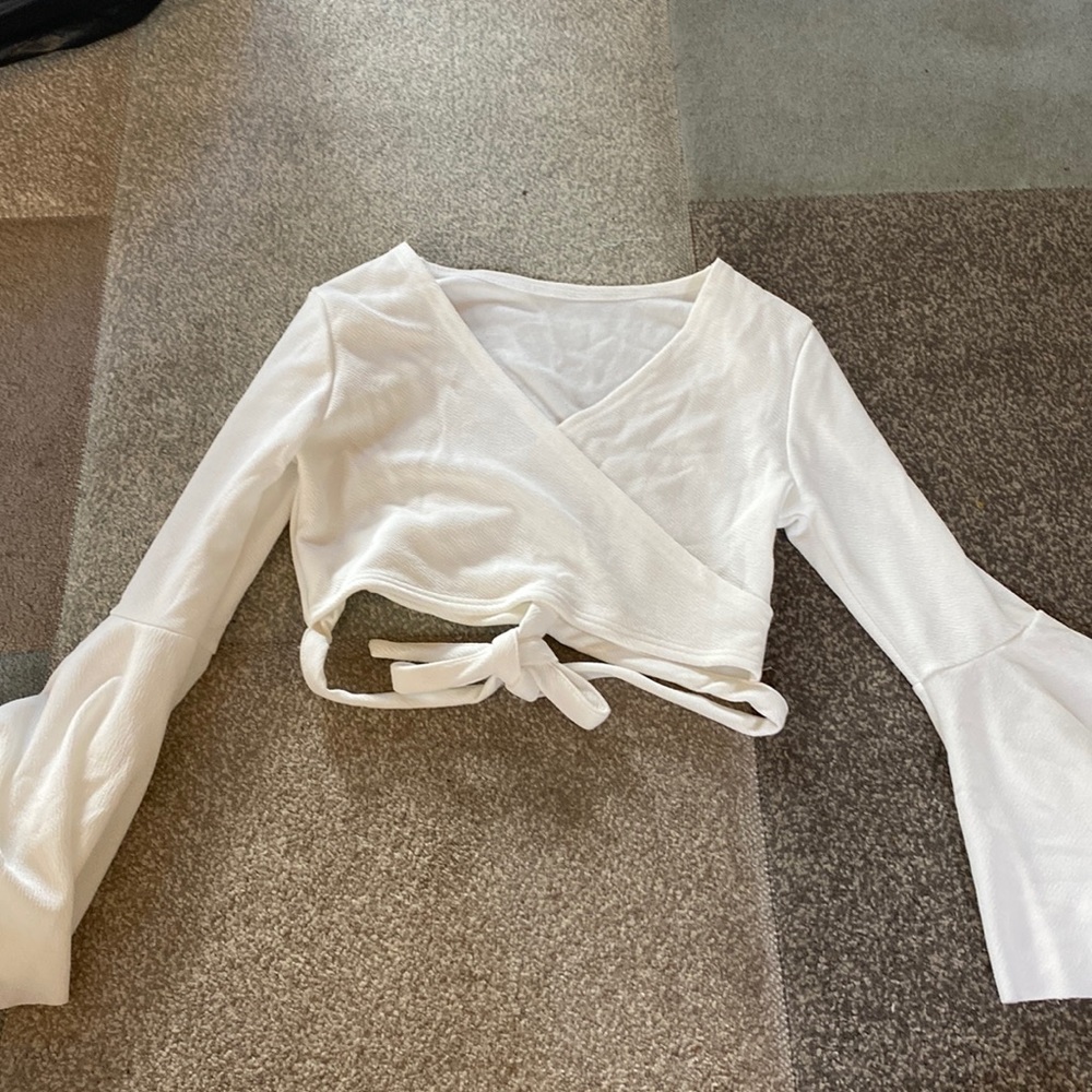 White flowy long sleeve crop top with a wrap around tie on the waist
